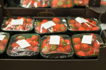 Strawberry in small boxes in supermarket