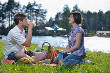 happy young couple having a picnic outdoor