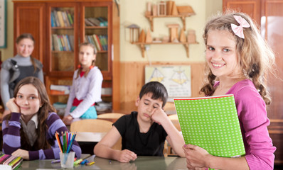 Pretty teen schoolgirl in front of class