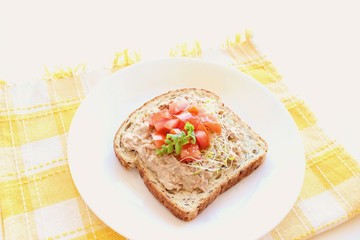 Open-faced tuna, tomato and alfalfa sandwich