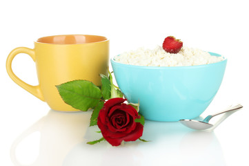 cottage cheese with strawberry in blue bowl and orange cup with