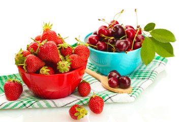 Ripe strawberries and cherry berries in bowls isolated on white