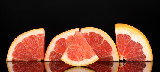 Sliced grapefruit isolated on black
