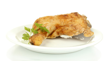 roasted chicken leg with parsley in the plate isolated on white