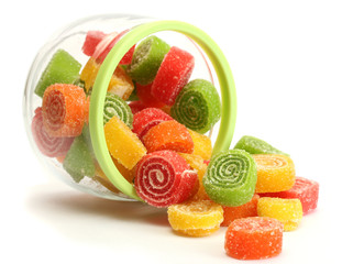 colorful jelly candies in glass jar isolated on white.