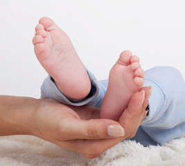 Baby feet held in mothers hand
