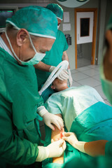 Surgeon using a scalpel to open a patient