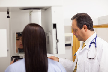 Doctor conducting a mammography on a patient