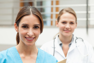 Fototapeta premium Smiling nurse and doctor standing