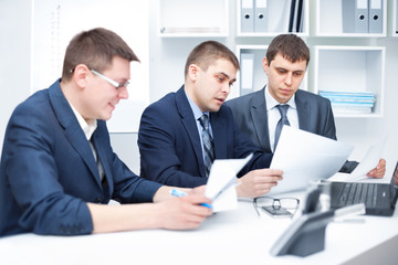 Team of young business men working together at office