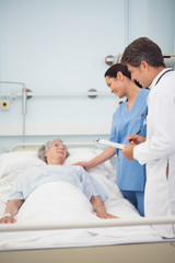 Doctor and nurse talking with a patient
