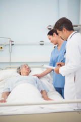 Doctor and nurse speaking to a patient