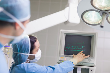 Doctor showing the ECG monitor