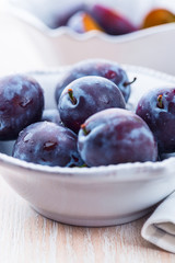 Close up of fresh plums in a bowl