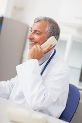 Fototapeta premium Smiling doctor calling