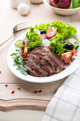 Grilled beef steak with fresh vegetables