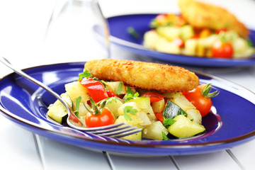 Fried fish on vegetables