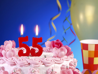 Birthday cake with red candles showing Nr. 55