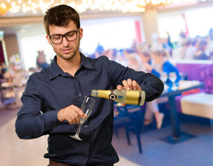 Young Man Pouring Champagne  