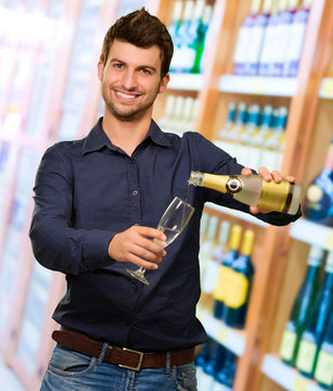 Young Man Pouring Champagne &nbsp;