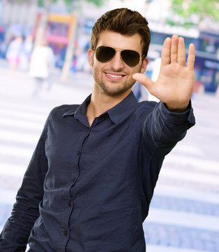Portrait Of Young Man Doing Stop Signal