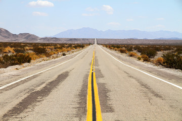 Long desert highway leading into Mojave Desert 