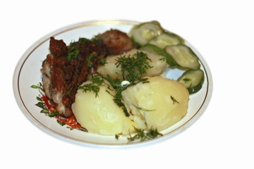 Fried meat and bolied potatoes and dill over isolated