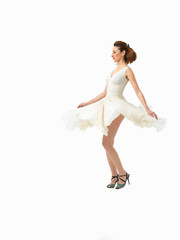 beautiful young woman twirling in white dress