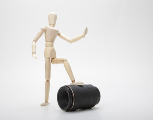 Wooden mannequin and photo lens