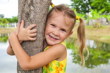 Girl hugging a tree