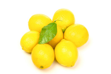 Seven lemons with green leaf