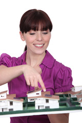Female architect presenting her model.