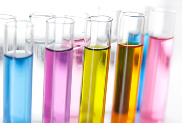 Set of test tubes with a colored liquids in a rack, close-up