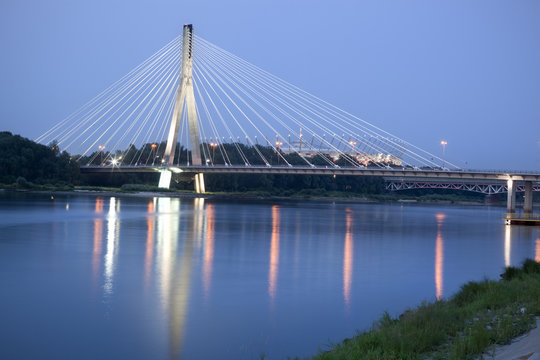 Fototapeta Modern bridge over Vistula River at night. Warsaw, Poland