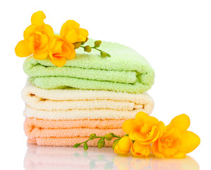 colorful towels and flowers isolated on white