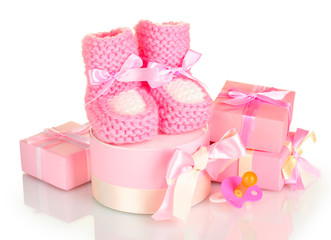 pink baby boots,  pacifier and gifts isolated on white