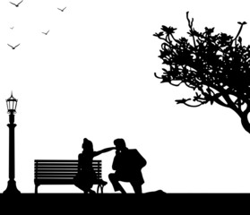 Couple, man and woman in park, he kisses her hand silhouette