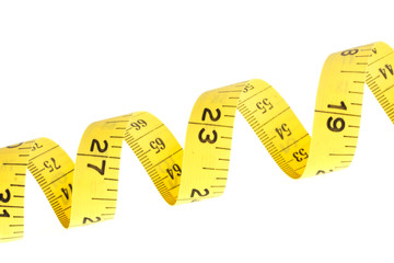 Yellow coiled tape measure on white