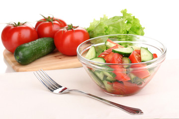 Fresh salad with tomatoes and cucumbers isolated on white