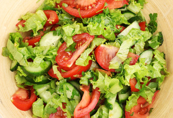Fresh salad with tomatoes and cucumbers close-up