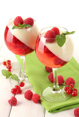 fruit jelly with berries in glasses on wooden table
