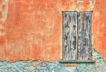 Old door by an orange wall
