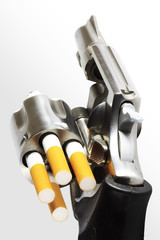 Revolver with cigarette bullets (clipping path)