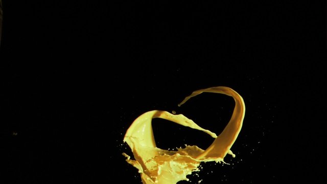 Yellow paint in super slow motion splashing