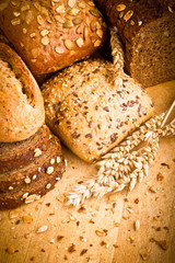 Collection of baked bread on wooden background