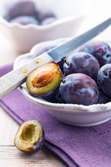 Fresh plums in a bowl