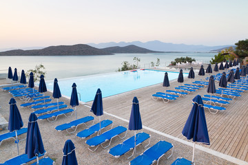 Swimming pool with sunbeds at Mirabello Bay in Greece