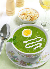 Cream soup with egg, sour cream and wine on the table