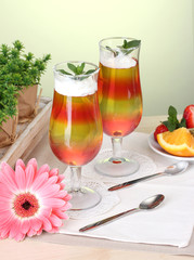 fruit jelly in glasses and fruits on table in cafe