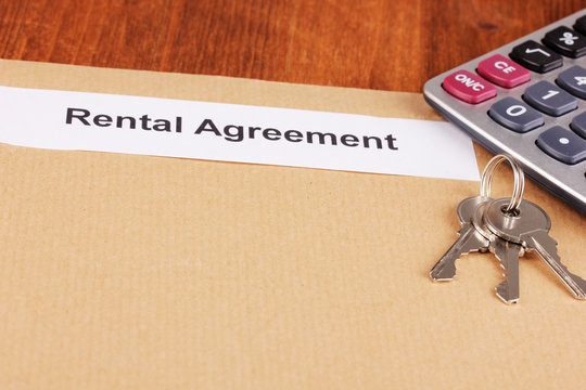 Rental agreement on wooden background close-up